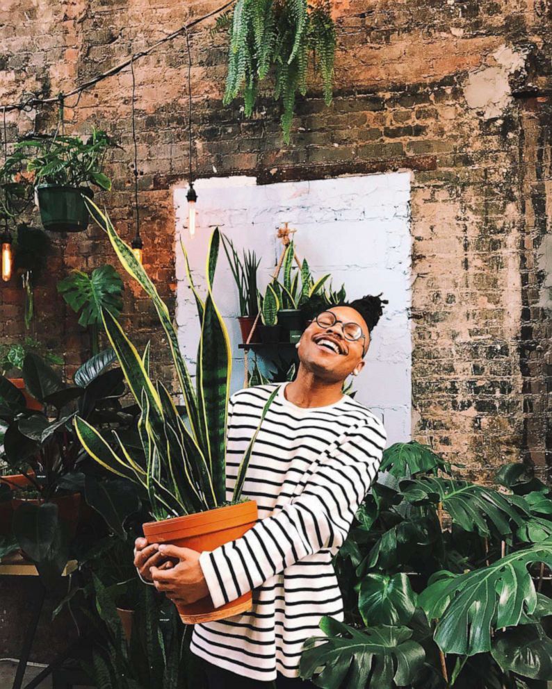 PHOTO: Christopher Griffin poses with a snake plant, his favorite plant.