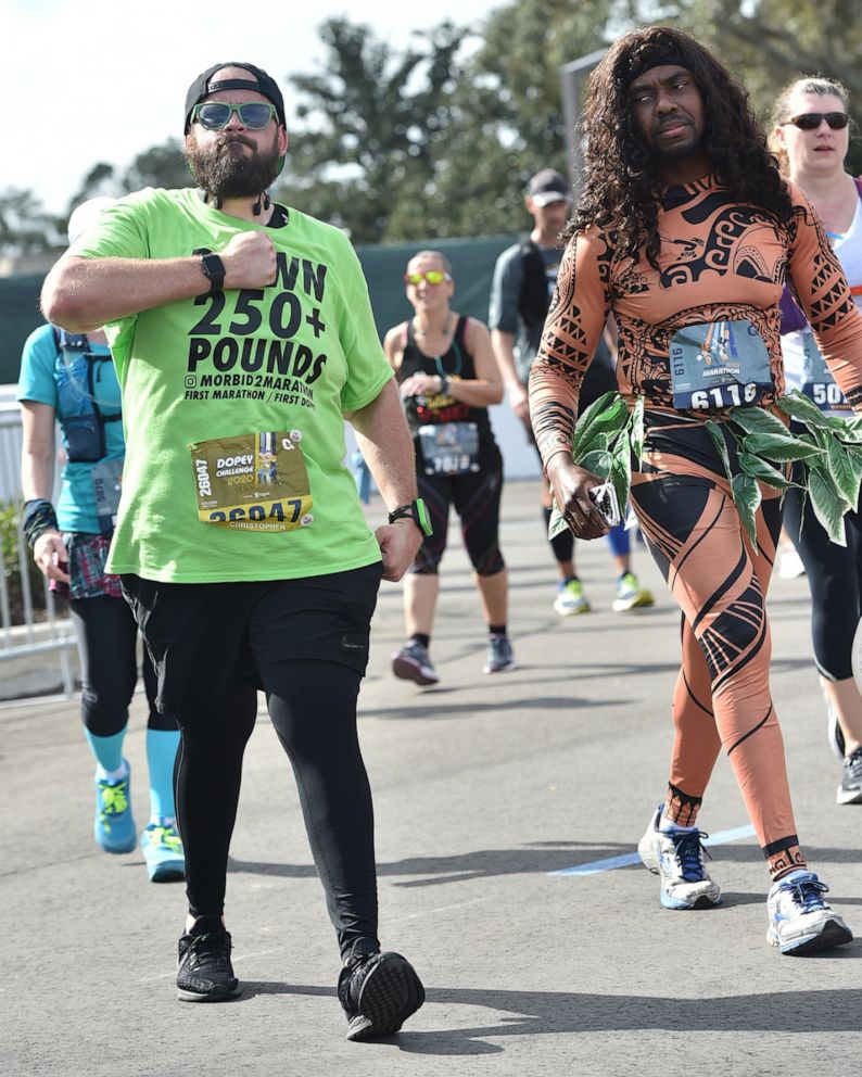 PHOTO: Christopher Hasty runs across the finish line of his first marathon to complete the "Dopey Challenge" at Walt Disney World.