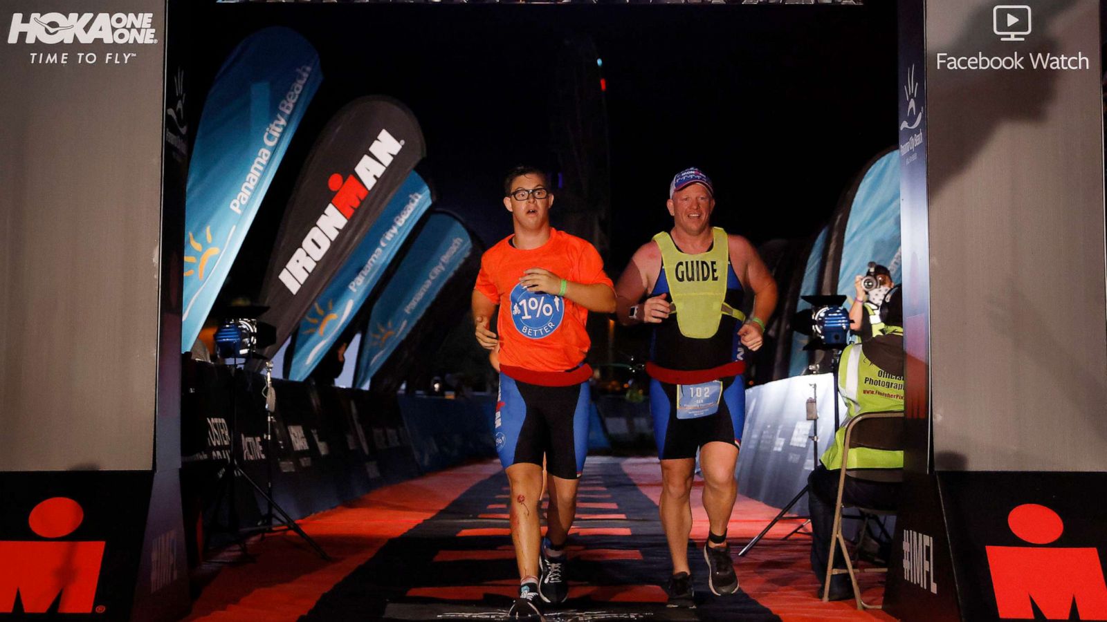 PHOTO: Chris Nikic and his guide Dan Grieb cross the finish line of IRONMAN Florida on Nov. 7, 2020 in Panama City Beach, Fla.