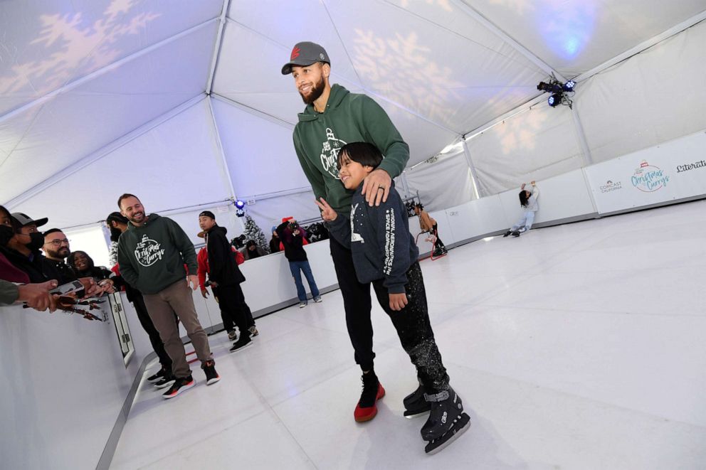 PHOTO: Chris Helfrich and Stephen Curry attend Eat. Learn. Play.'s 10th Annual Christmas with the Currys Celebration at The Bridge Yard on Dec. 11, 2022 in Oakland, Ca. 