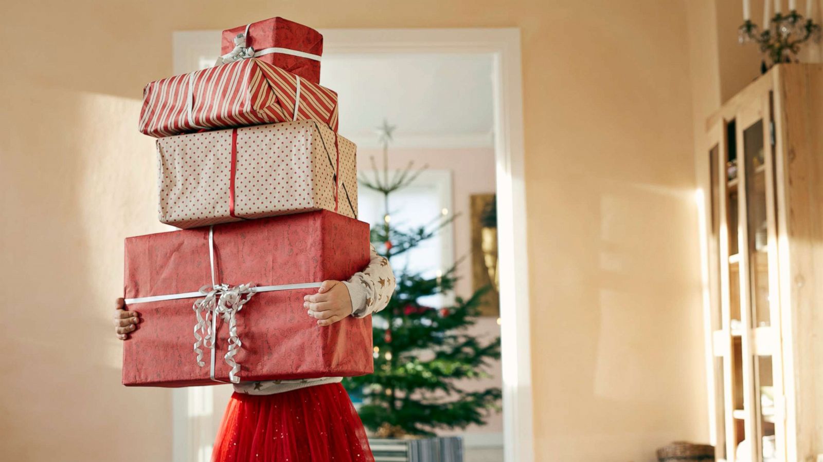 PHOTO: A young child carrying Christmas presents is depicted in this stock photo.