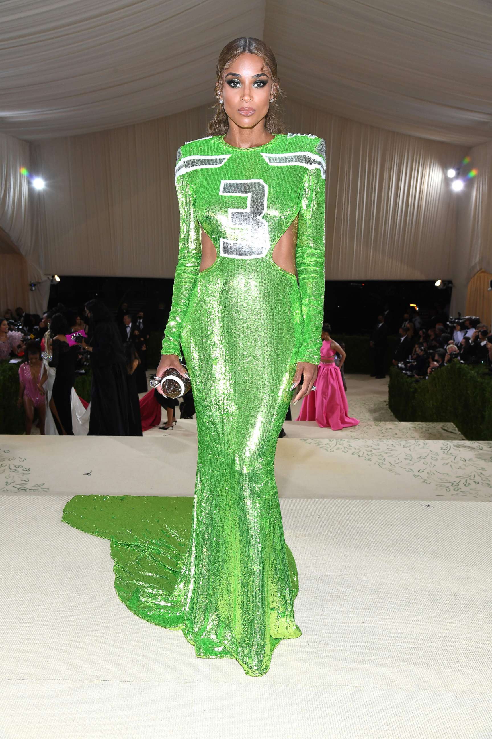 Ciara wears a lime green dress in her husband Russell Wilson's Seattle Seahawks' colors with his number three on the front at The 2021 Met Gala Celebrating In America: A Lexicon Of Fashion at Metropolitan Museum of Art on Sept. 13, 2021, in New York City.
