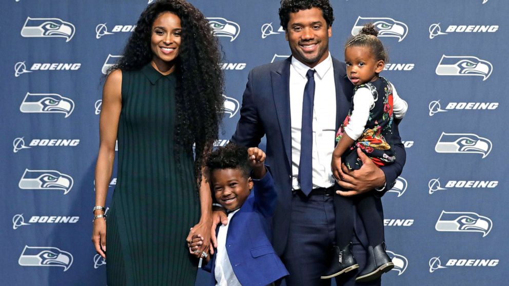 Seattle Seahawks quarterback Russell Wilson poses for photos with his wife Ciara, their daughter Sienna, and Ciara's son Future in Renton, Wash., Aug. 13, 2019.