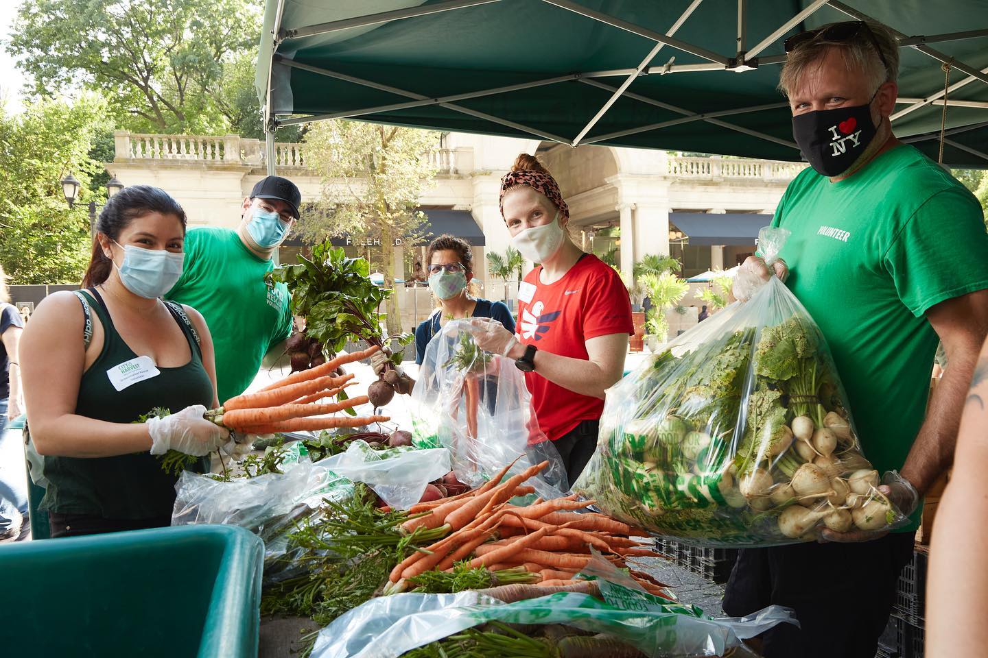 PHOTO: Volunteers with fresh produce at Union Square Greenmarket for City Harvest.