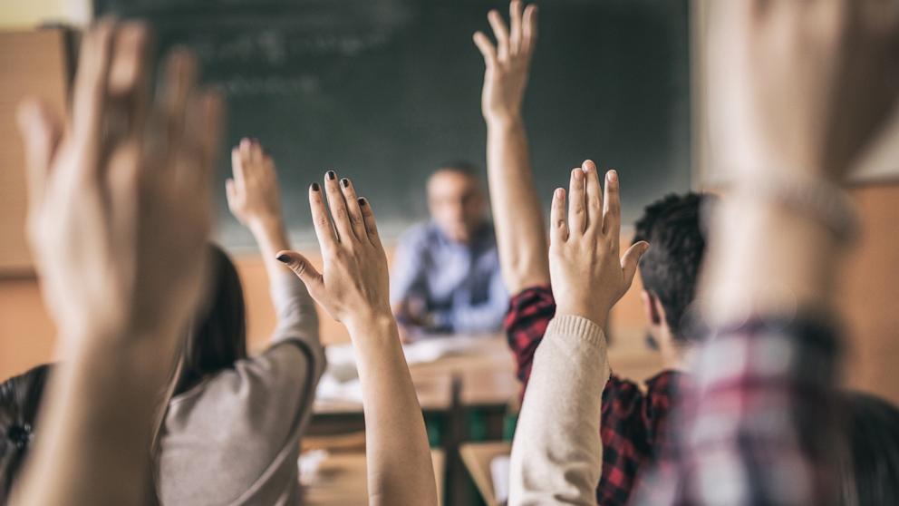 PHOTO: In this undated stock photo, students in a classroom are seen raising their hands.