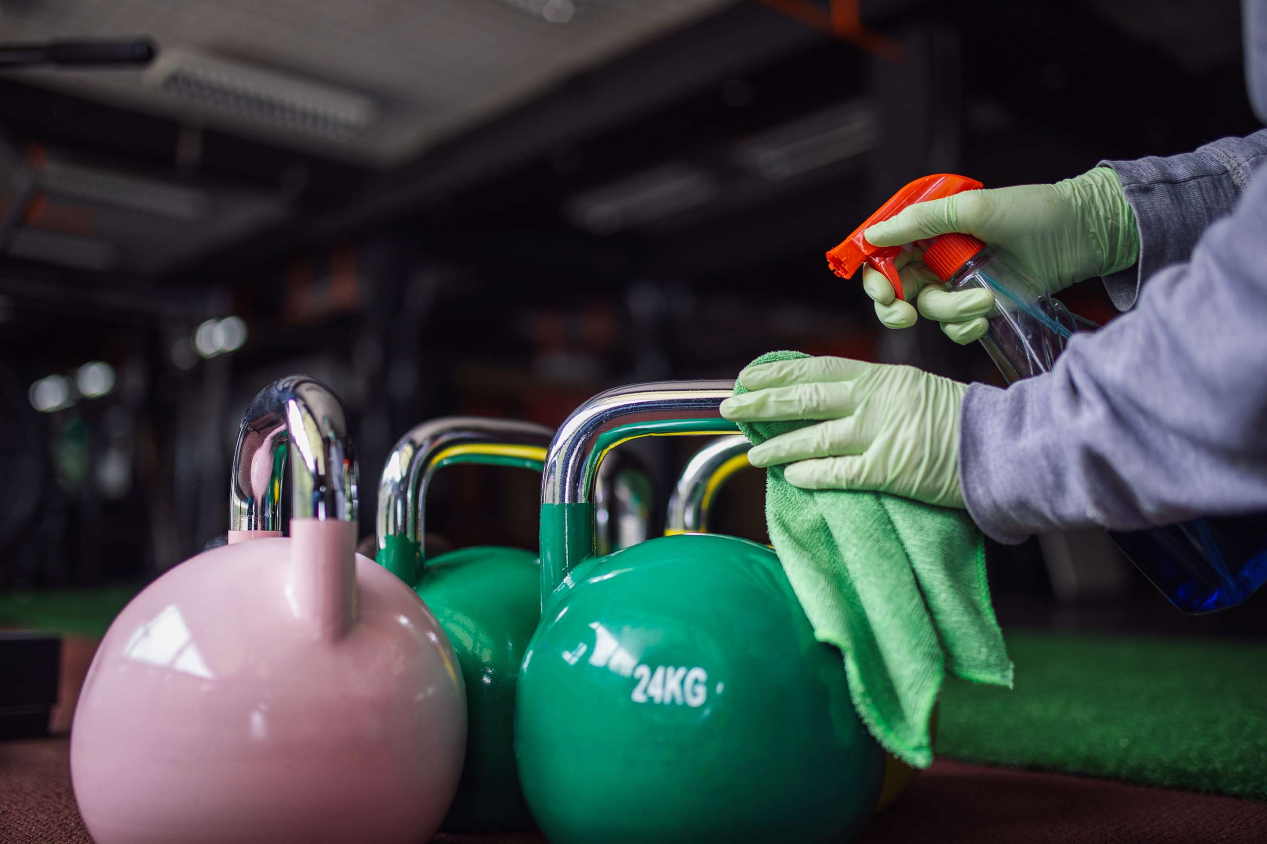 PHOTO: A woman cleans and disinfecting equipment in gym without people in this undated stock photo.