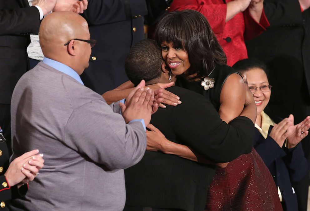PHOTO: In this Jan. 29, 2013, first lady Michelle Obama hugs Cleopatra Cowley-Pendleton as Nathaniel A. Pendleton Sr. looks on, before U.S. President Barack Obama's State of the Union speech at the U.S. Capitol in Washington, D.C.