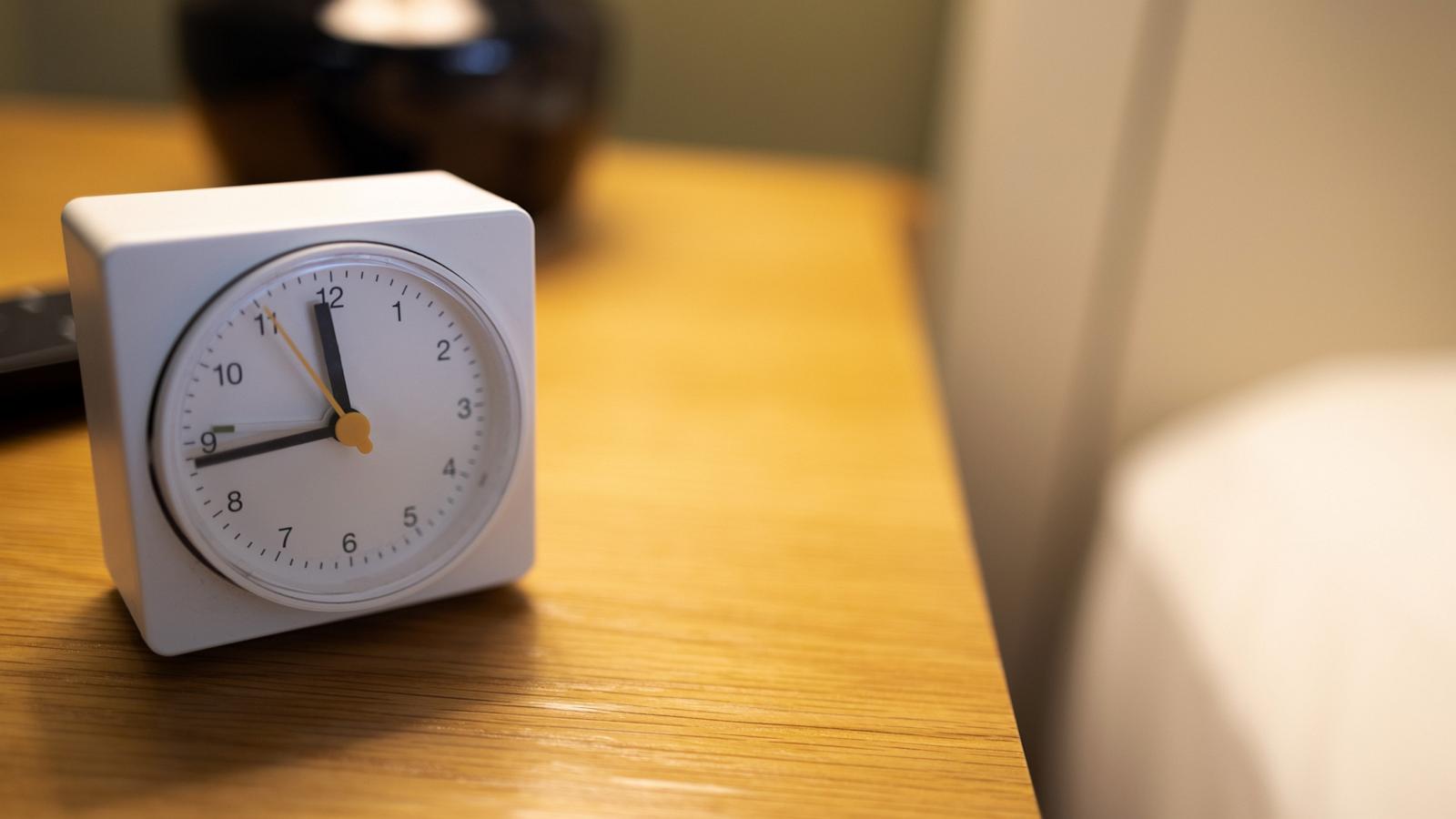 PHOTO: Stock photo of a clock on a nightstand.