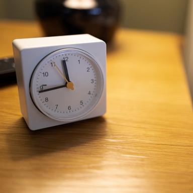 [PHOTO: Stock photo of a clock on a nightstand.]