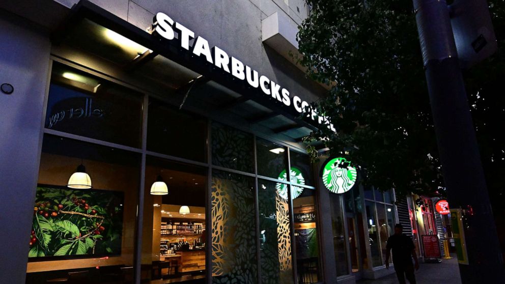 PHOTO: A pedestrian walks past a Starbucks closed for the day in Los Angeles, July 12, 2022.