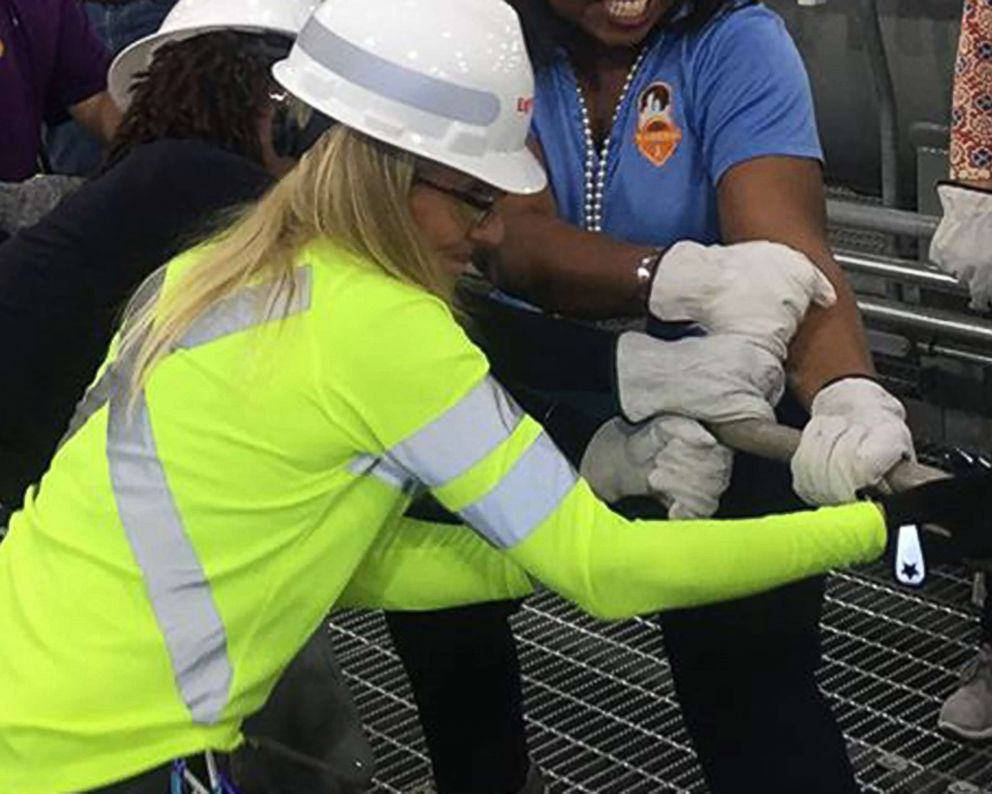 PHOTO: SeeHerWork founder, Jane Henry, working with other women in the field wearing SeeHerWork gear and clothing.