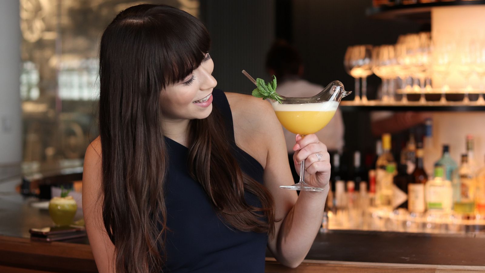 PHOTO: Zoe Moore holds the "Lady Bird" cocktail.