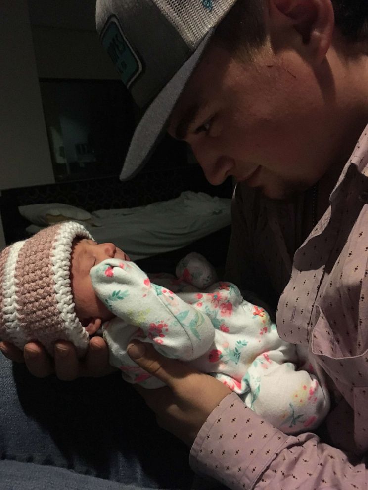 PHOTO: Cody Comer holds his newborn daughter, Carrigan.