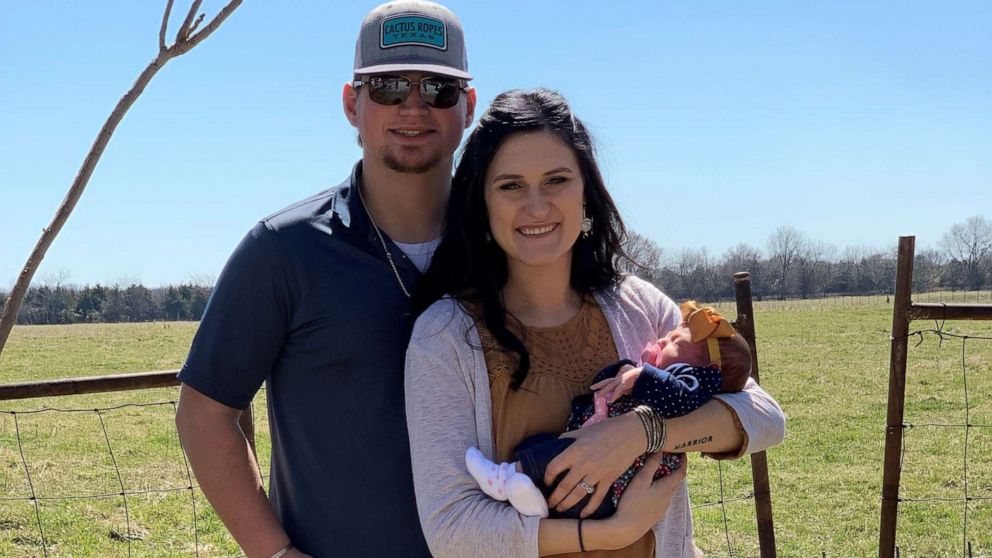 PHOTO: Cody 1: Cody and Chandra Comer pose with their daughter, Carrigan.