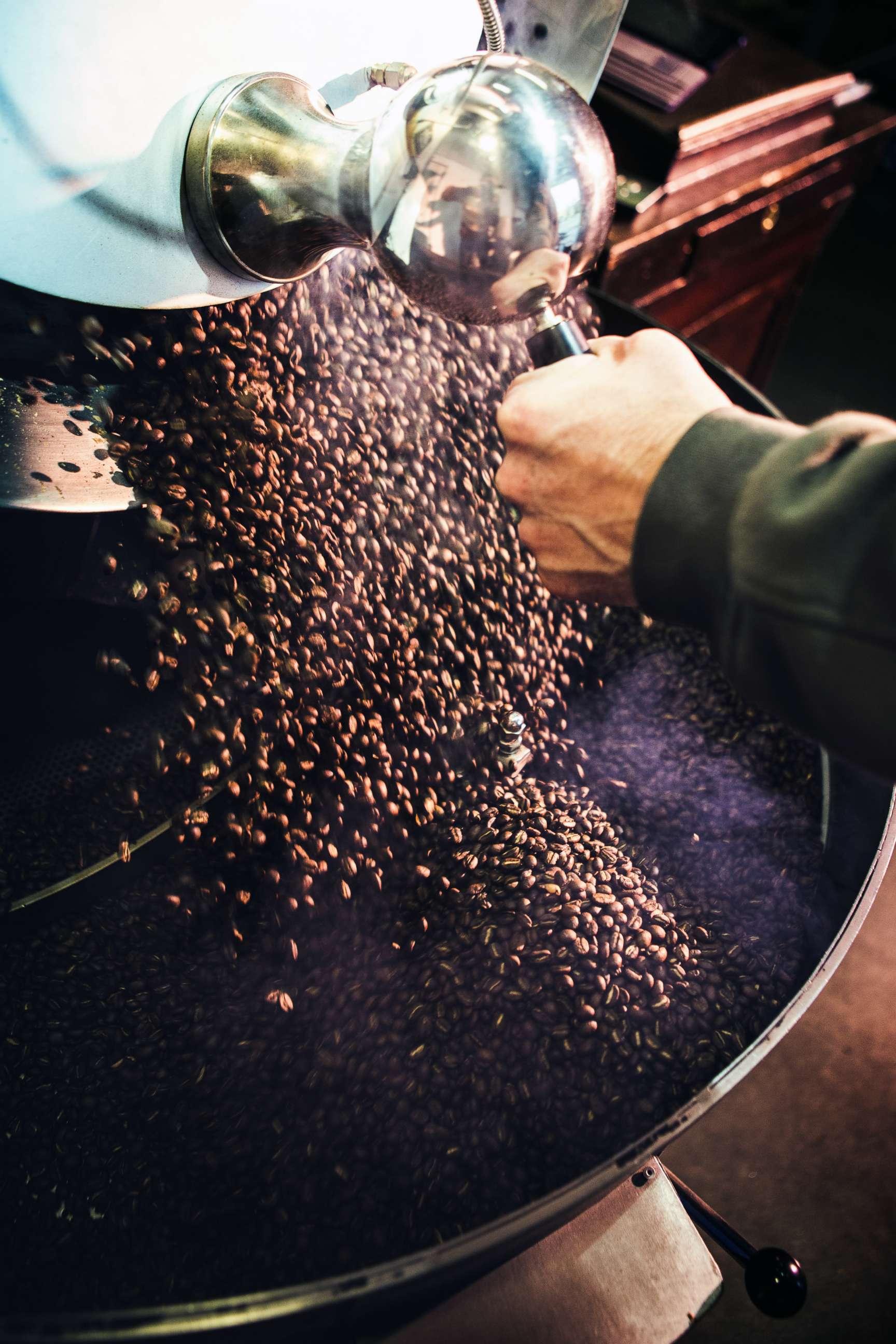 PHOTO: In this stock photo coffee beans are put in a large industrial roaster. 