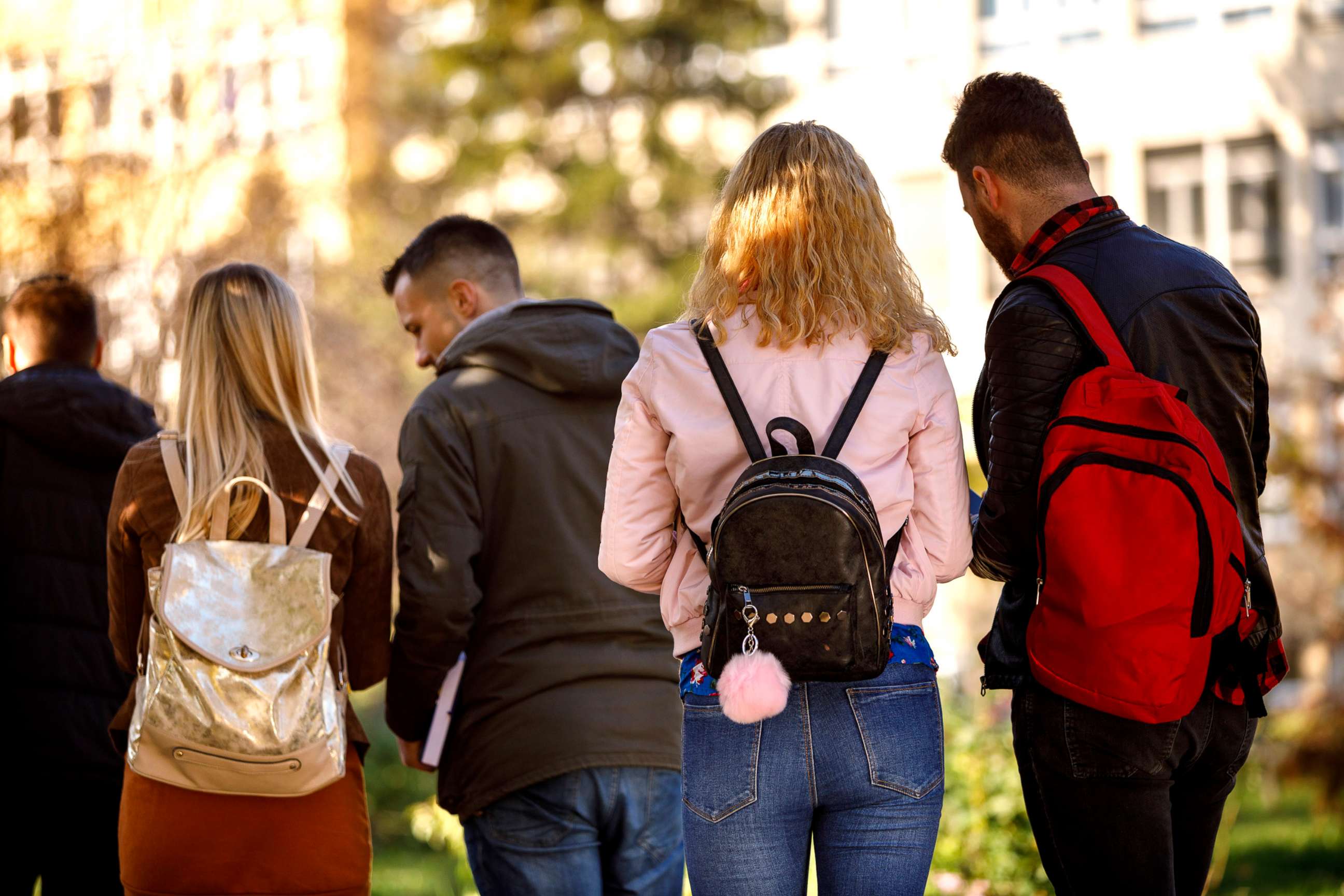 PHOTO: A group of college students walk on their university campus in a stock image.