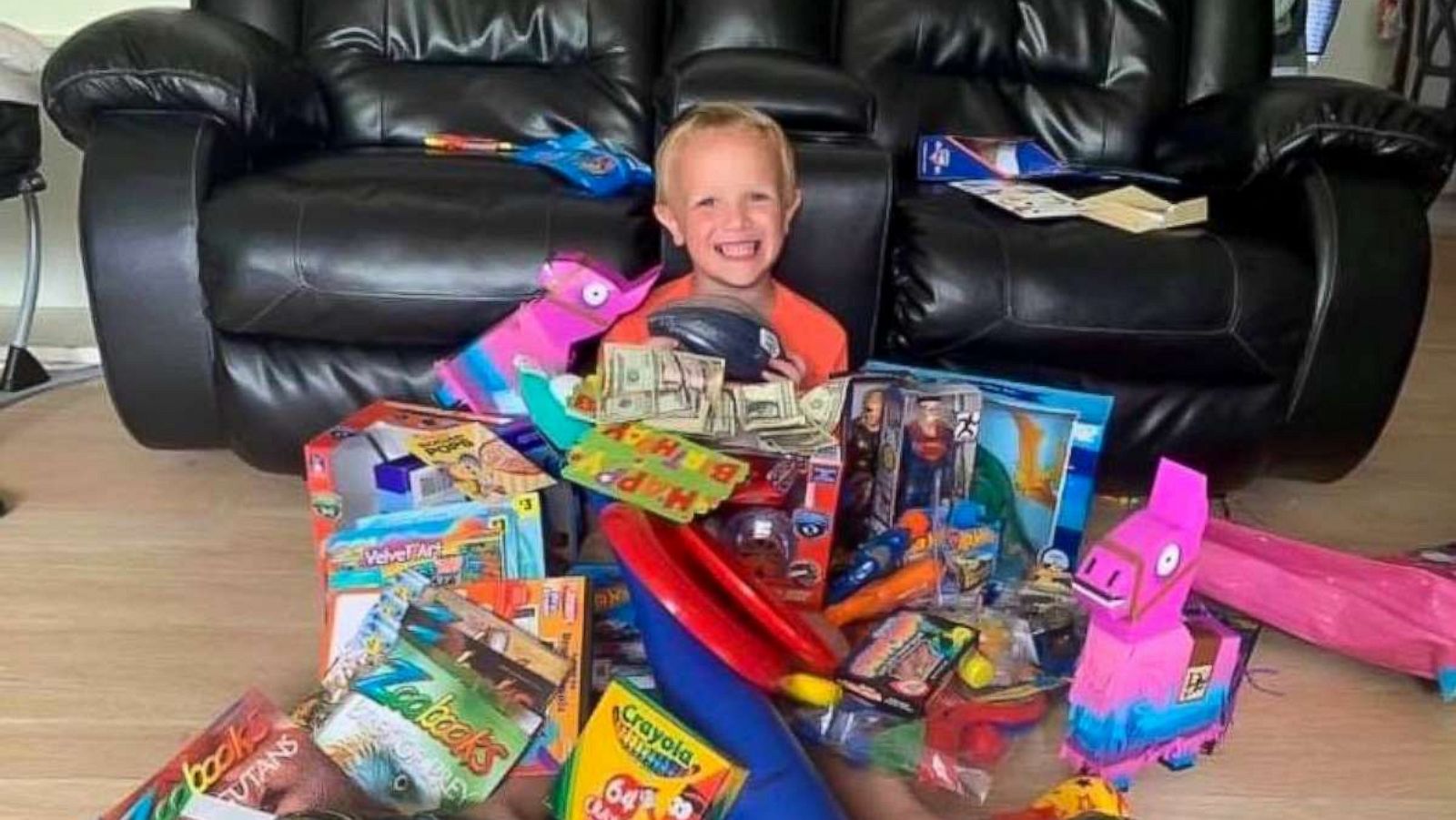 PHOTO: Colten Raymer is seen buried in his birthday gifts after a birthday party at Keystone Beach Park in Keystone Heights, Florida.