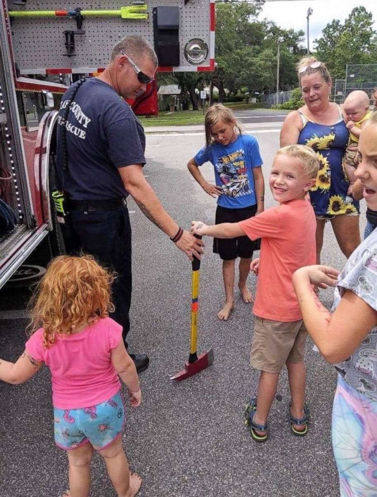 PHOTO: Colten Raymer and his new friends are shown having fun with the firefighters and fire truck.