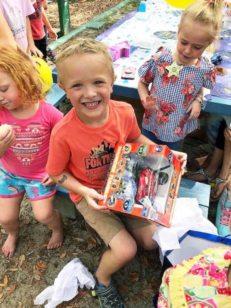 PHOTO: Colten is shown opening some of his presents in the park.