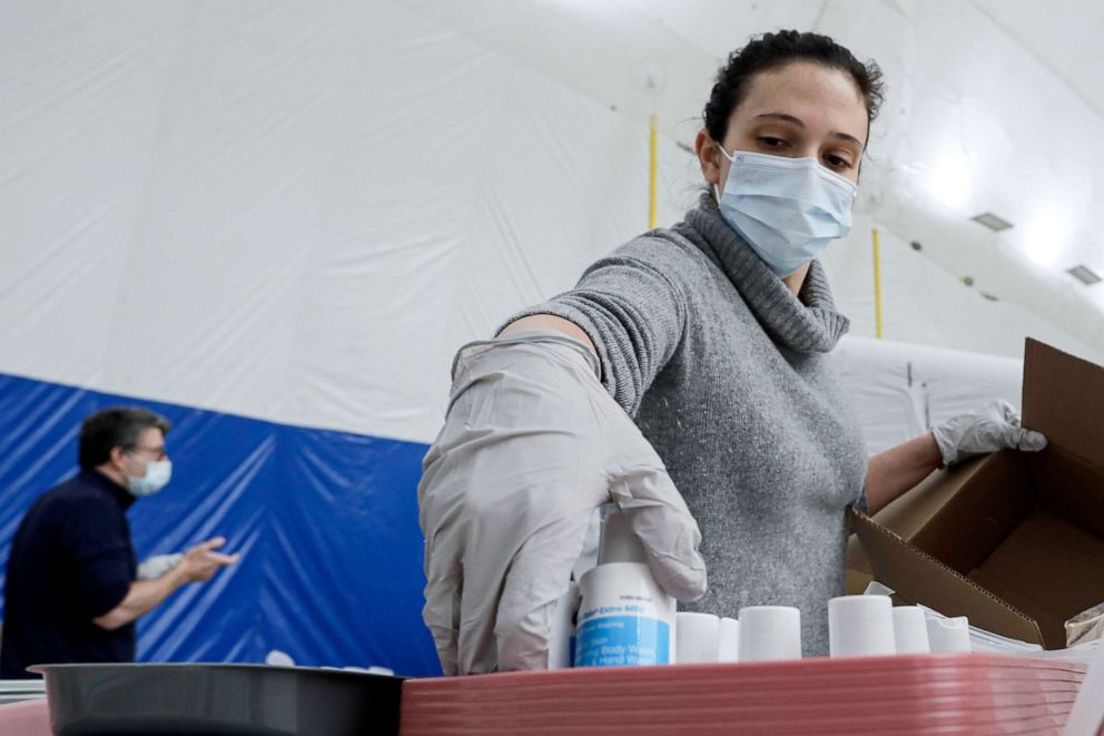 PHOTO: Maggie Martino helps prepare supplies as workers help build a medical facility for New York-Presbyterian at Columbia University's Baker Field on April 11, 2020, in New York.