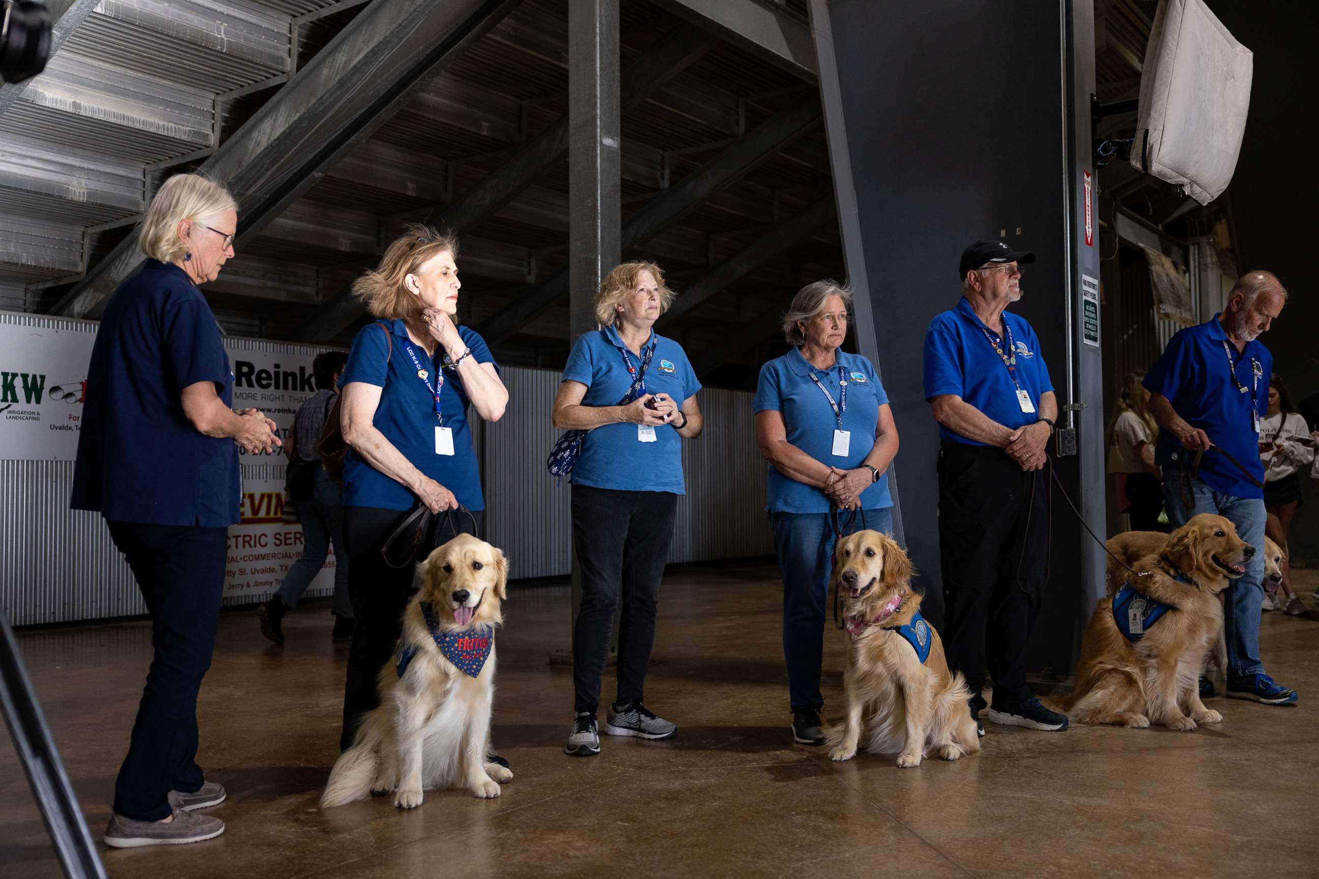 PHOTO: Volunteers with comfort dogs from Lutheran Church Charities offer their services to mourners at a vigil, May 25, 2022, for the 21 people killed at Robb Elementary School on May 24 in Uvalde, Texas.
