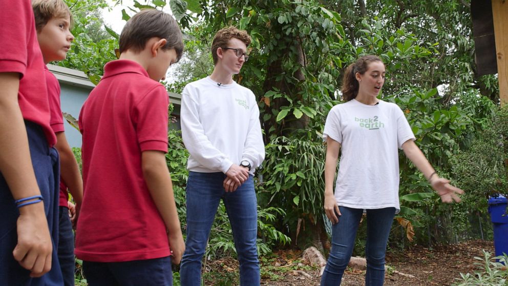 PHOTO: Back2earth founders Ugo and Emma Angeletti explain the composting process to school children.