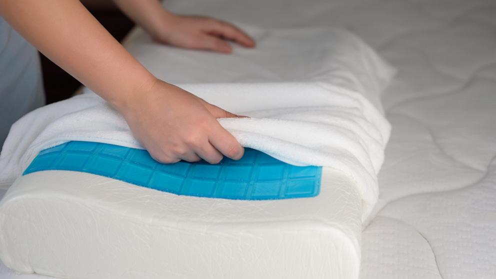 PHOTO: A person puts a cover on an orthopedic pillow with cooling gel. 