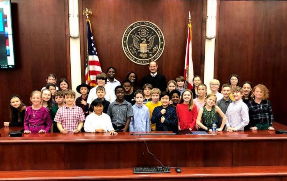 PHOTO:  Annmarie Small poses with her students and a judge at Leon County Federal Courthouse in Tallahassee, Florida.