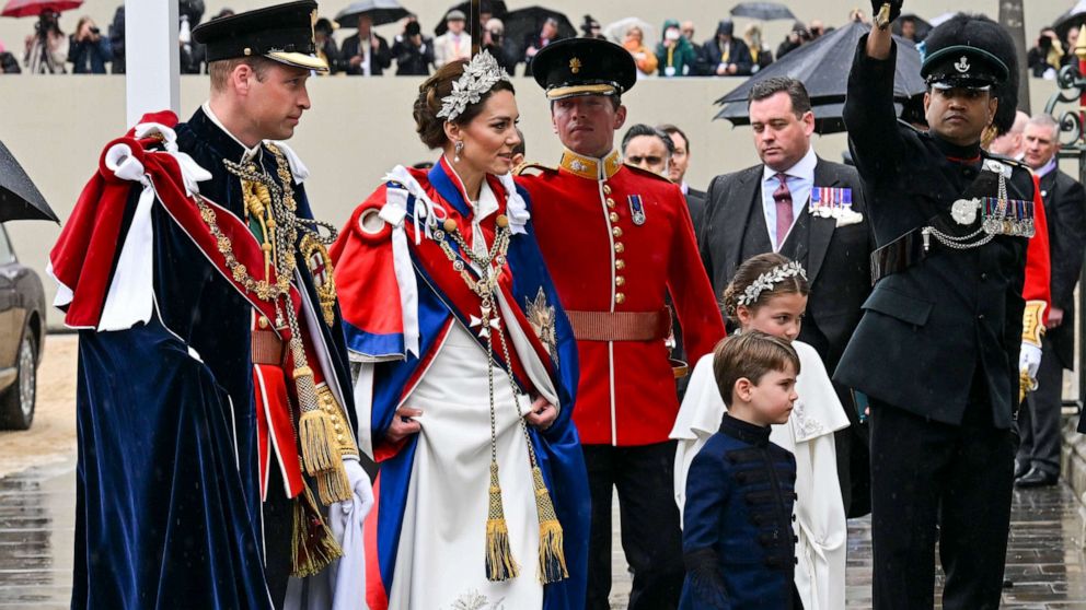 PHOTO: Prince William, Prince of Wales, Catherine, Princess of Wales, Prince Louis and Princess Charlotte arrive for the Coronation of King Charles III and Queen Camilla at Westminster Abbey on May 6, 2023 in London.