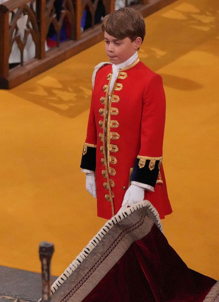 PHOTO: Britain's Prince George of Wales holds the robe of Britain's King Charles III at Westminster Abbey, in central London on May 6, 2023, during the Coronation.