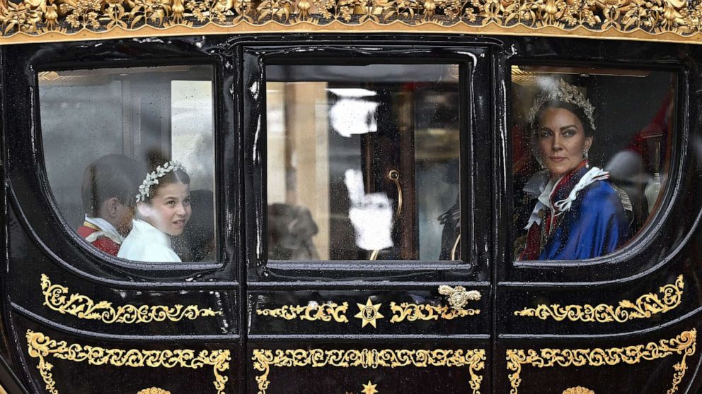 PHOTO: Britain's Prince William, Catherine, Princess of Wales, Princess Charlotte, Prince George and Prince Louis travel in a carriage from Westminster Abbey following Britain's King Charles' coronation ceremony, in London, May 6, 2023.