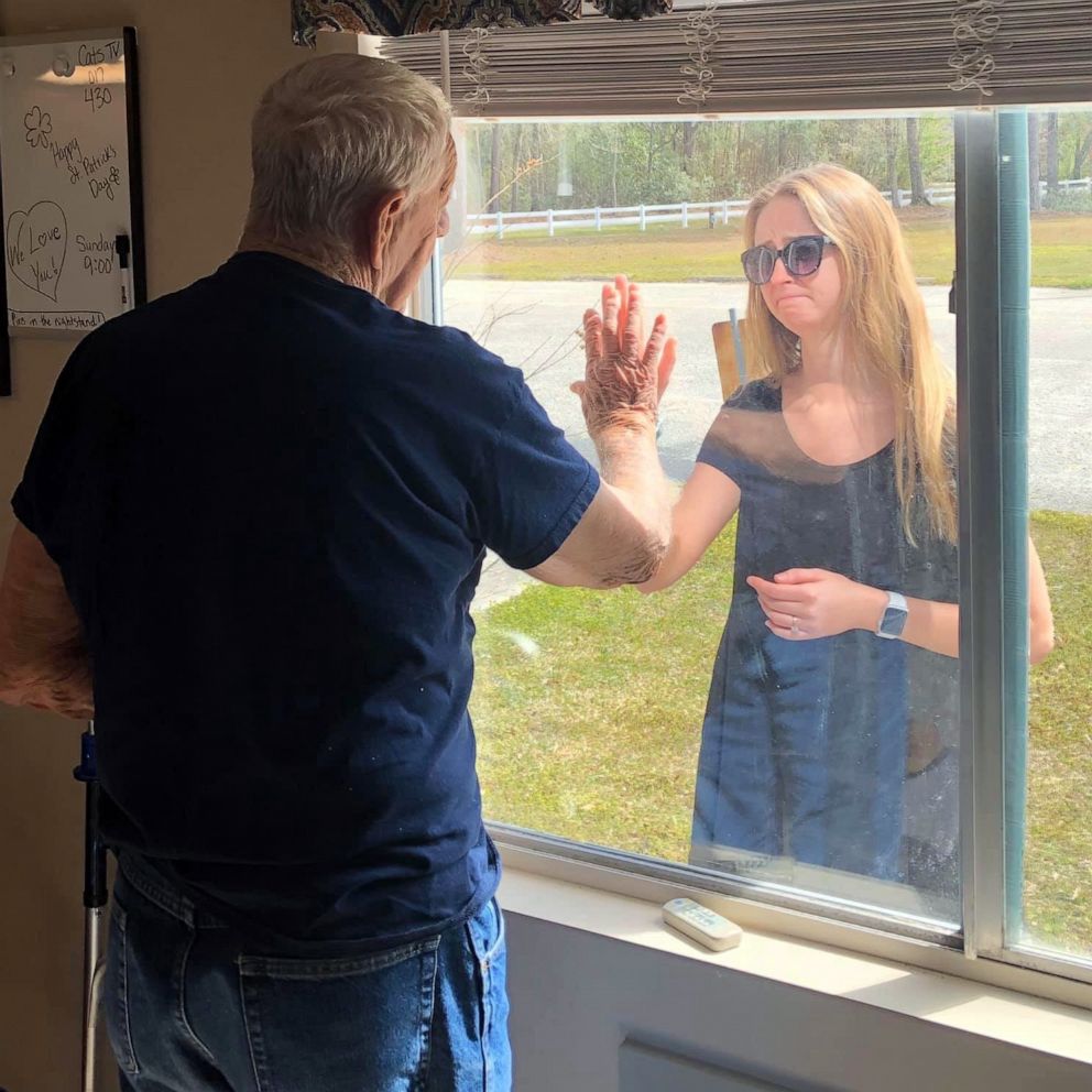 VIDEO: Woman surprises quarantined grandpa with engagement news through nursing home window