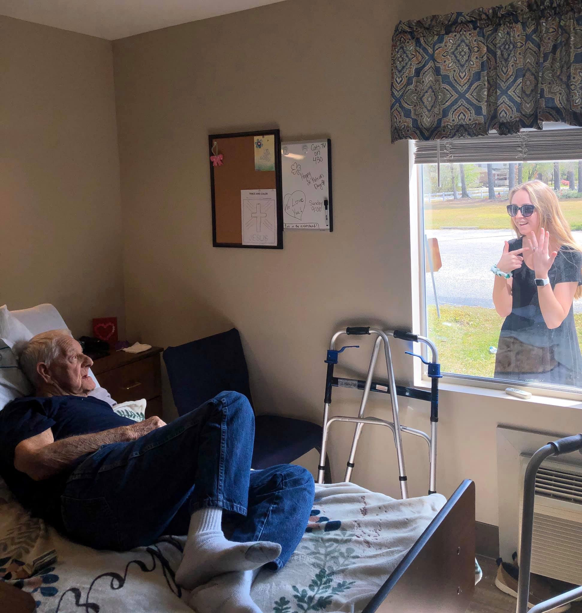 PHOTO: Carly Boyd announces her engagement to her grandfather Shelton Mahala, 87, through his nursing home window in Lake Waccamaw, N.C., in a photo shared on Facebook March 16, 2020.