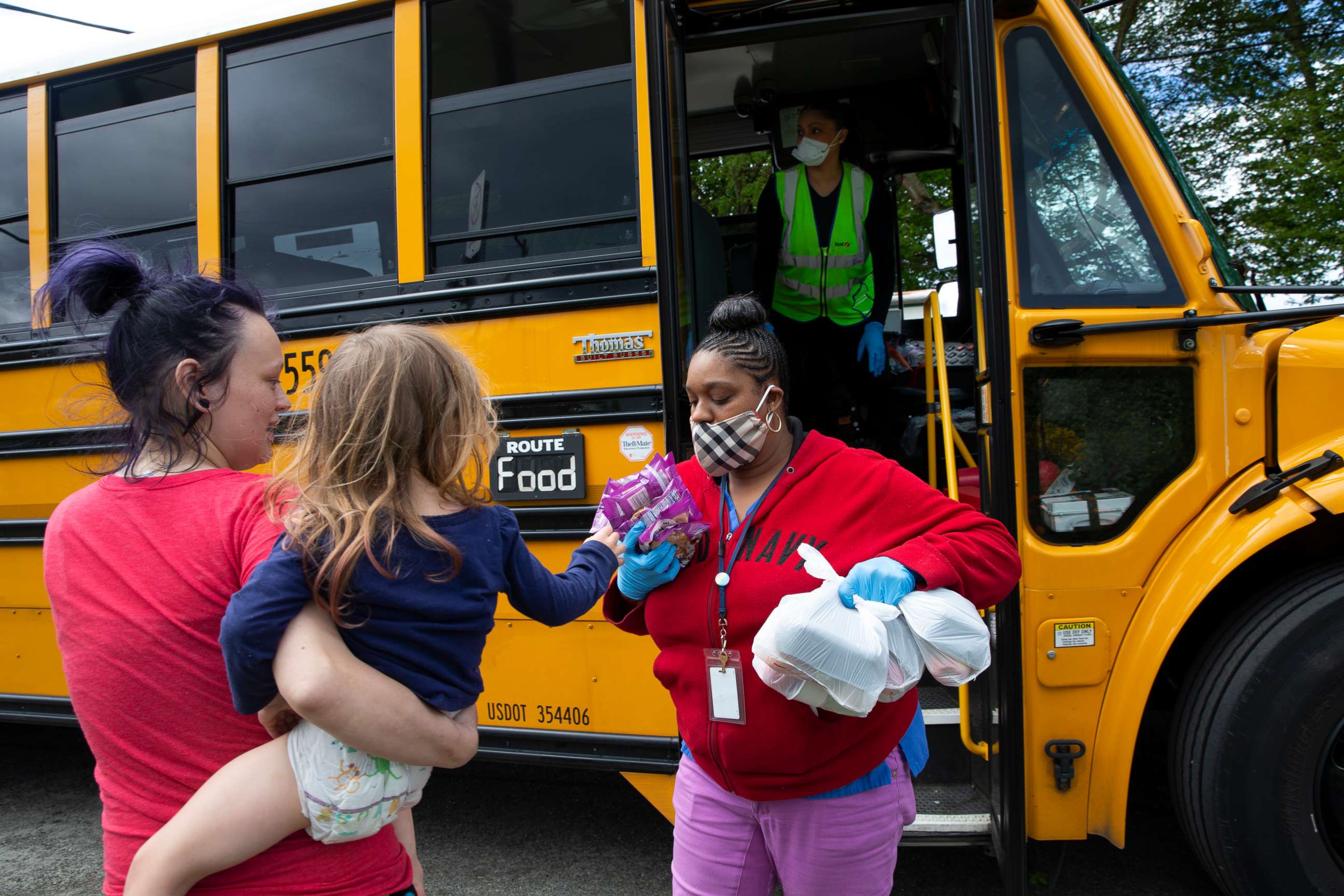 PHOTO: Bus driver Treva White and nutritionist Shaunte Fields deliver meals to children and their families on May 6, 2020, in Seattle.