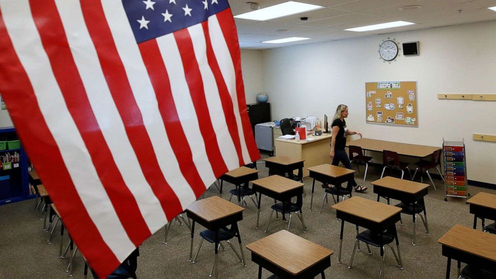 PHOTO: A teacher sets up her classroom to restart school at Freedom Preparatory Academy in Provo, Utah, Aug. 13, 2020.