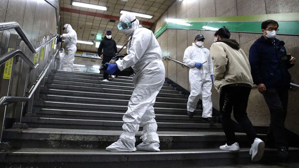 Disinfection workers wearing protective gears spray anti-septic solution against the coronavirus (COVID-19) at a subway station on Feb. 21, 2020 in Seoul, South Korea.