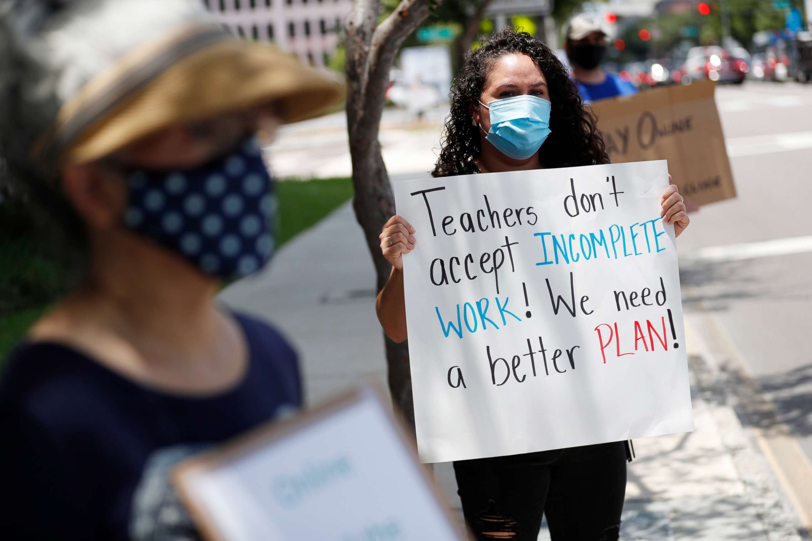 PHOTO: First grade teacher Yolanda Vasquez stands in protest along with other teachers and counselors in front of the Hillsborough County Schools District Office on July 16, 2020, in Tampa, Fla.