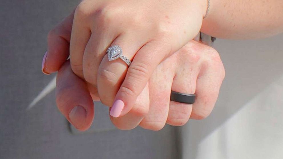 PHOTO: Savannah Kulenic and Dylan Perkins hold hands during their wedding ceremony on a North Carolina beach, April 10, 2020.