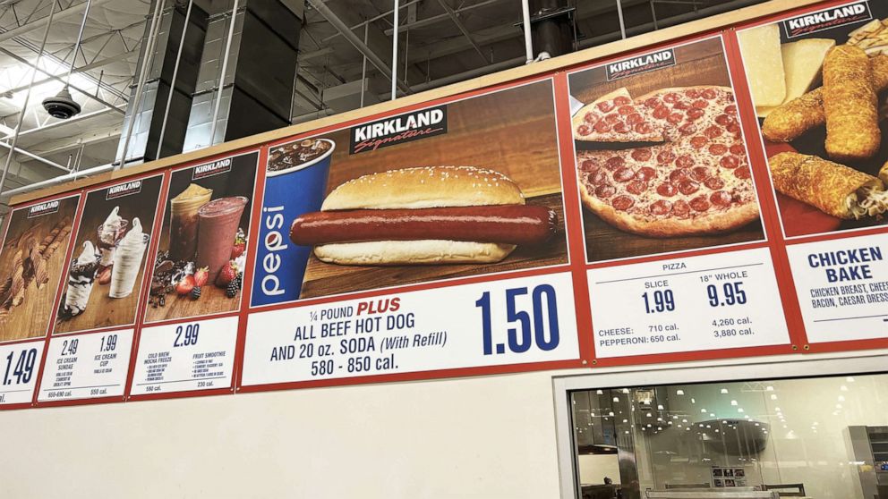 PHOTO: In this July 3, 2022, file photo, signs listing prices at Costco food court, including the price for Costco's hot dog and fountain soda combination, are shown in Danville, Calif.