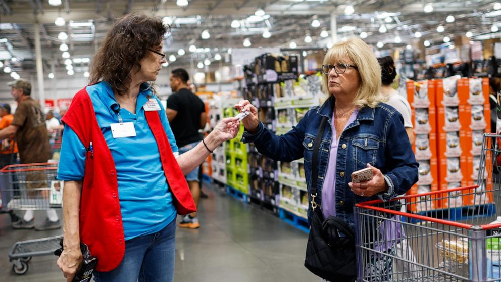 PHOTO: A staff speaks to a customer inside a Costco store on June 28, 2023 in Teterboro, New Jersey.