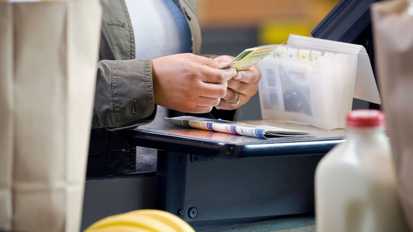 PHOTO: A person holds coupons in a grocery store in this undated stock photo.