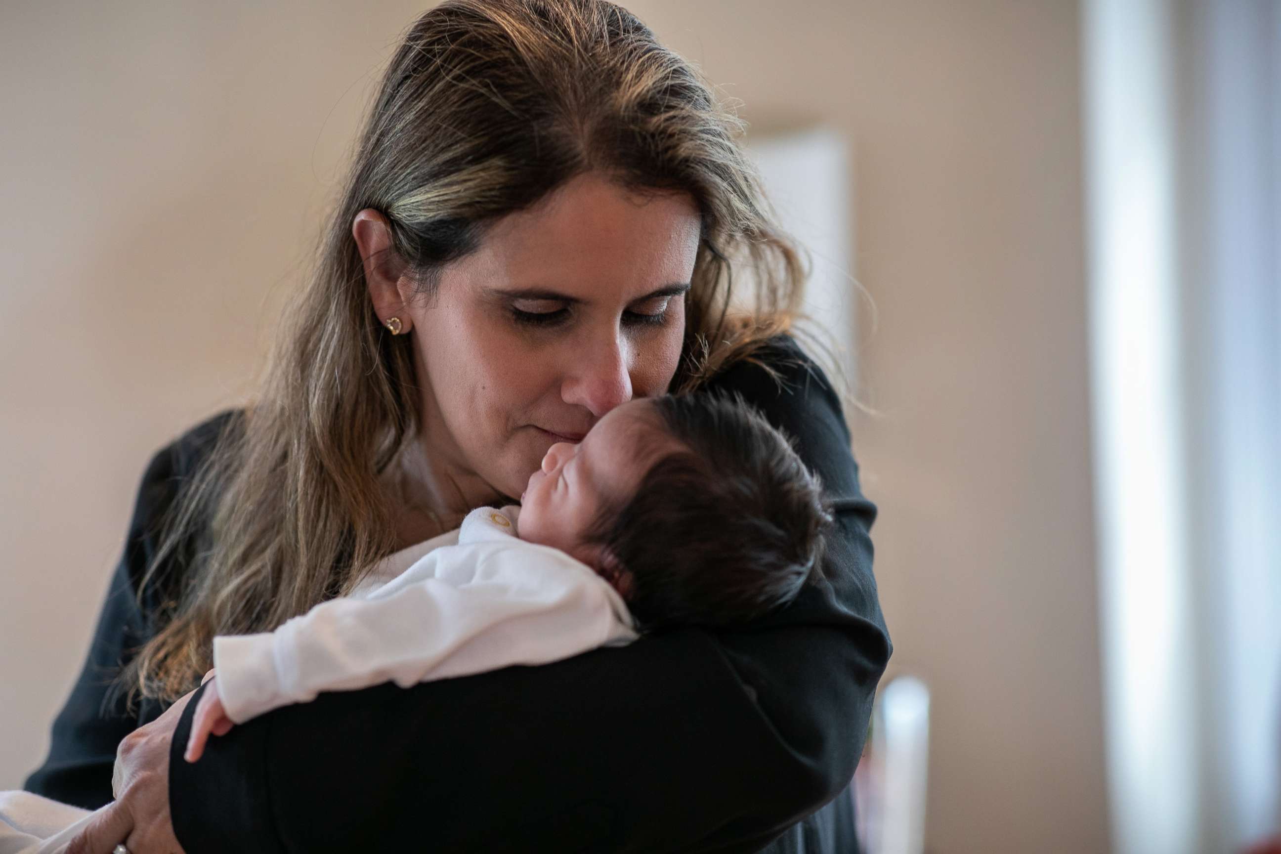 PHOTO: Stamford Elementary school teacher Luciana Lira, 32, kisses Neysel before showing the newborn for the first time to his immigrant mother Zully, a Guatemalan asylum seeker, and her son Junior, 7,  via Zoom on April 20, 2020, in Stamford, Conn.