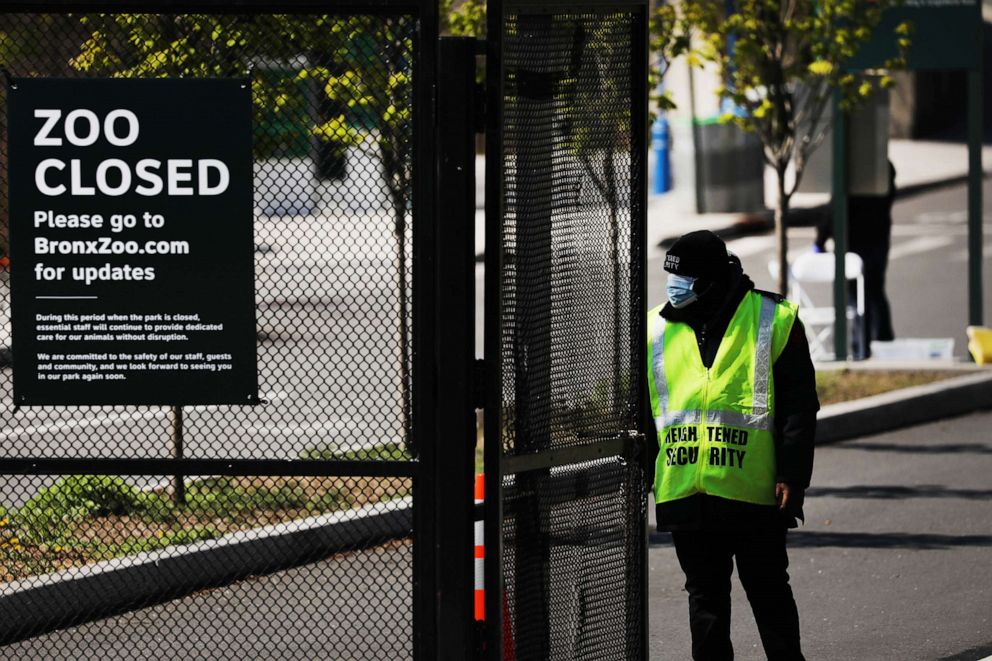 PHOTO: A guard stands at the entrance to the Bronx Zoo on April 06, 2020, in New York City. A four-year-old tiger named Nadia at the zoo tested positive for COVID-19, the Wildlife Conservation Society said in a statement on April 5.
