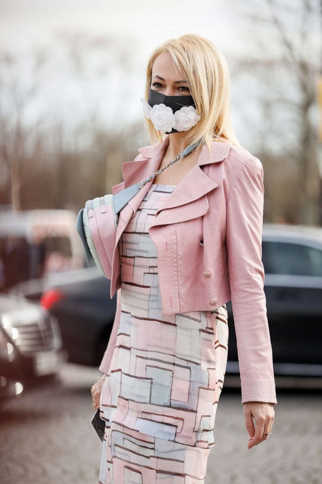 PHOTO: A guest wearing Chanel bag, pink jacket and a face mask outside the Chanel show during Paris Fashion Week Womenswear Fall/Winter 2020/2021, March 3, 2020 in Paris.
