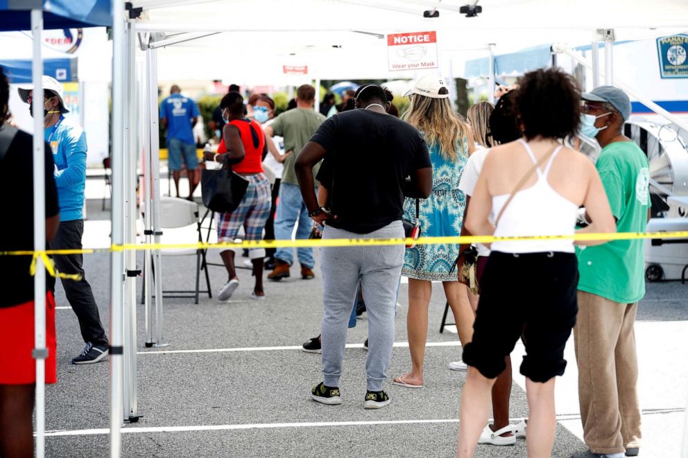 PHOTO: Patients wait in line to get a swab test at a COVID-19 mobile testing site hosted by the Manatee County Florida Department of Health in Palmetto, Fla., Aug. 2, 2021.