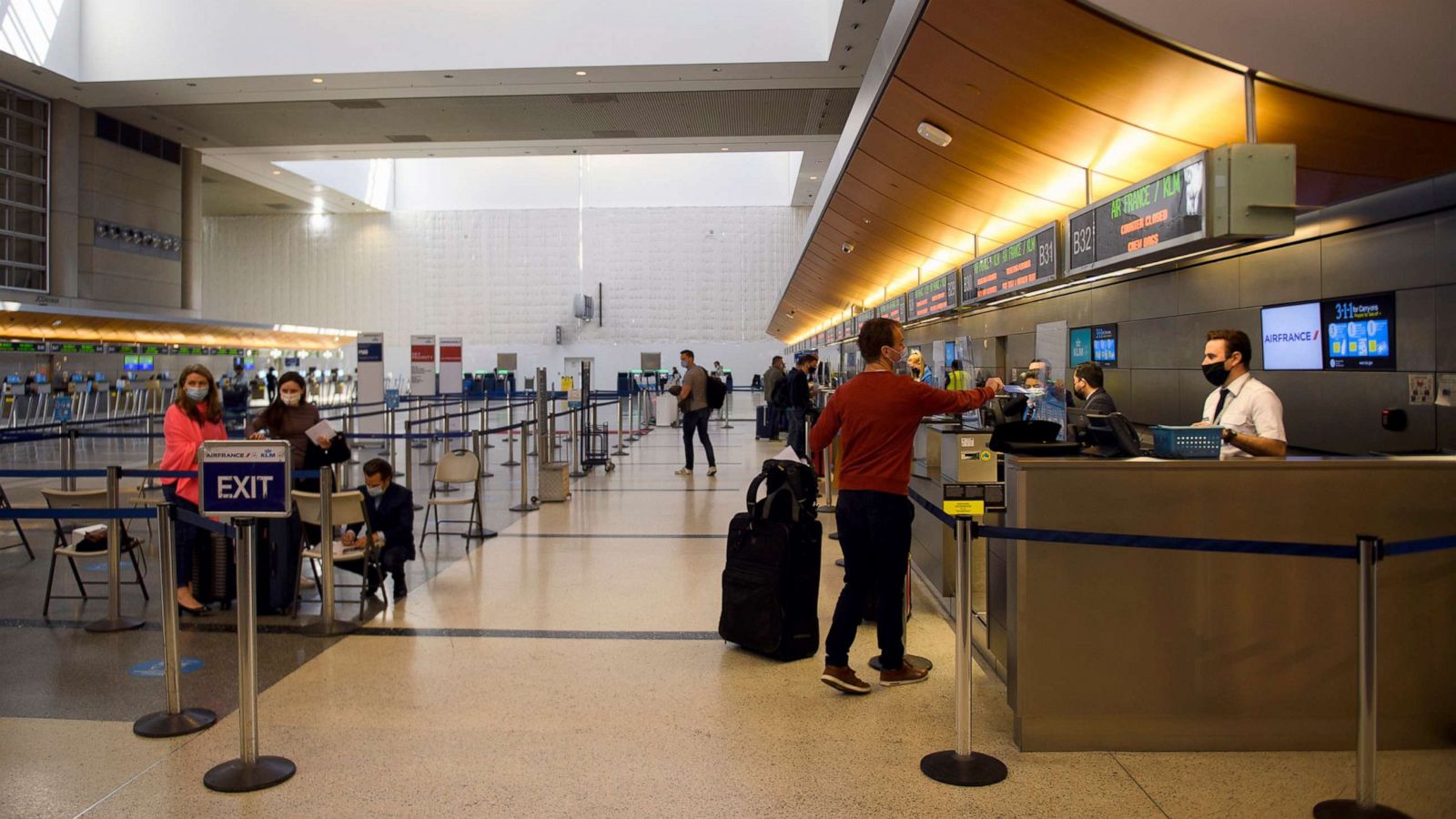 PHOTO: Passengers check-in for a flight at the Air France and KLM counter inside the Tom Bradley International Terminal at Los Angeles International Airport, Jan. 25, 2021.