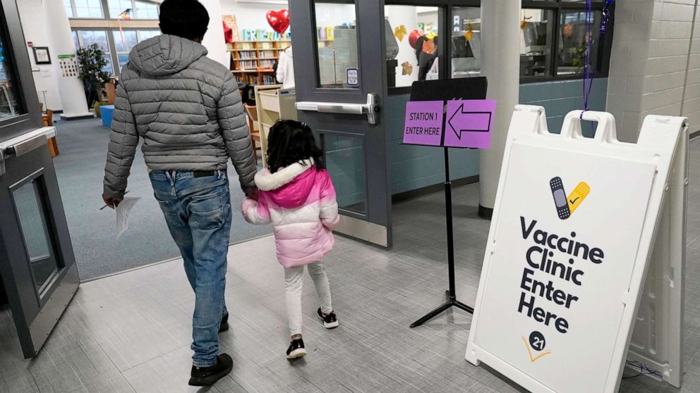 PHOTO: An information sign is displayed as a child arrives with her parent to receive the Pfizer COVID-19 vaccine for children 5 to 11-years-old at London Middle School in Wheeling, Ill., Nov. 17, 2021.