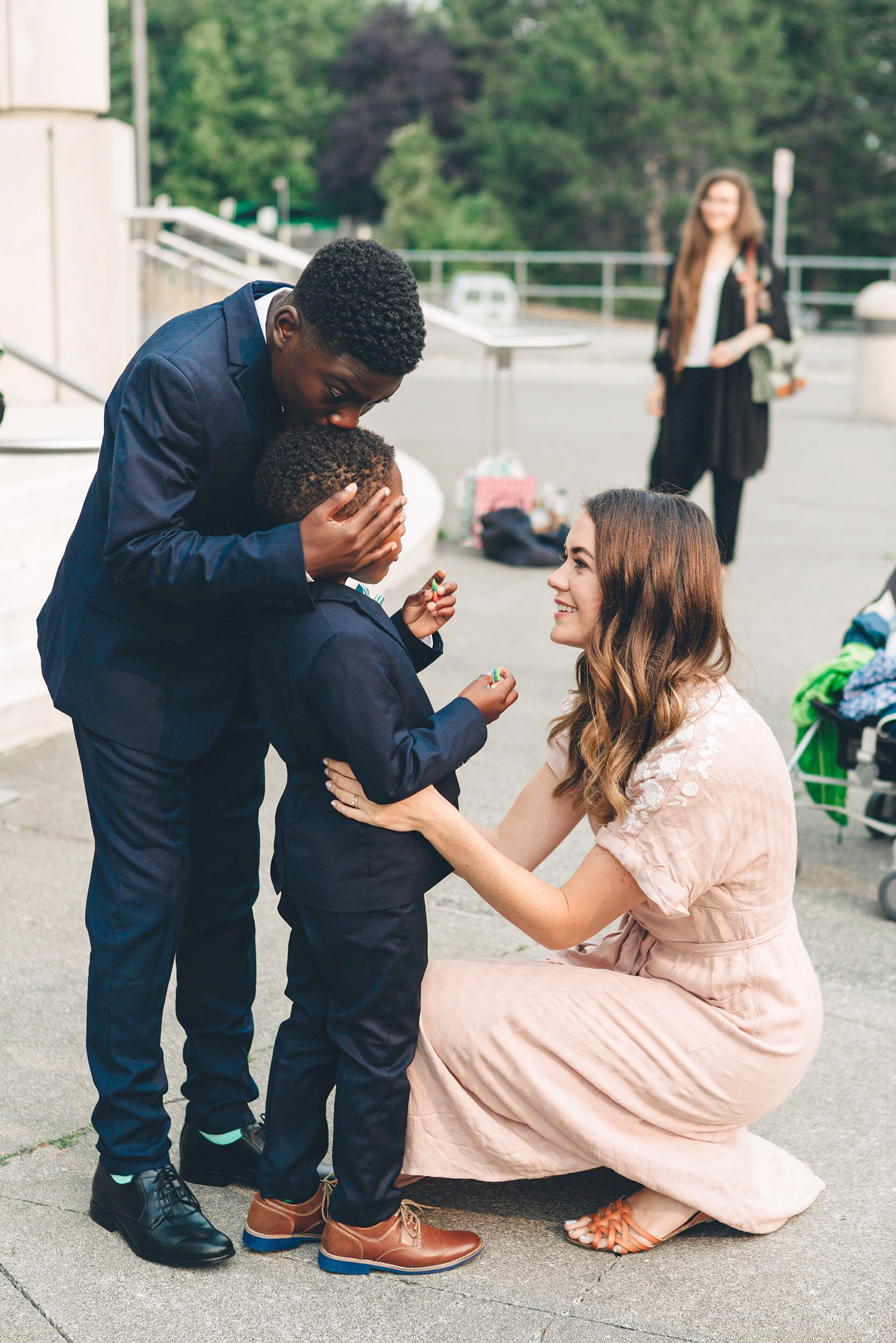 PHOTO: Dayshawn kisses Michael on the head while Sara Cozard looks on in this adoption day photograph, Aug. 13, 2018.