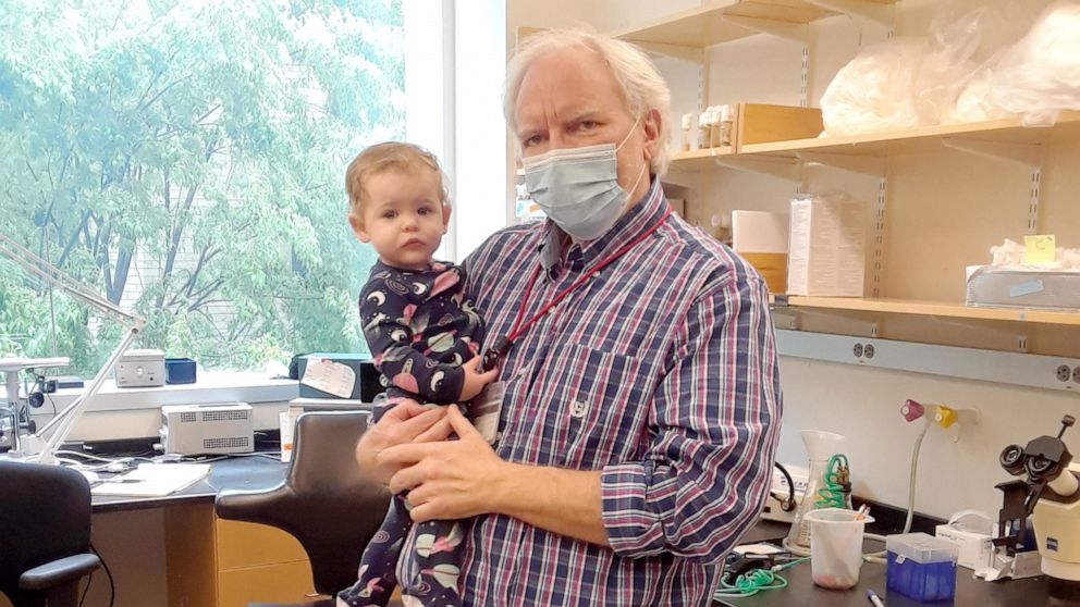 PHOTO: MIT professor Troy Littleton holds Katie, the daughter of his graduate student Karen Cunningham.