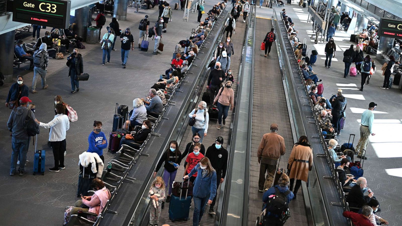 PHOTO: Travelers wear protective face masks at Denver International Airport, on Nov. 30, 2021 in Denver.